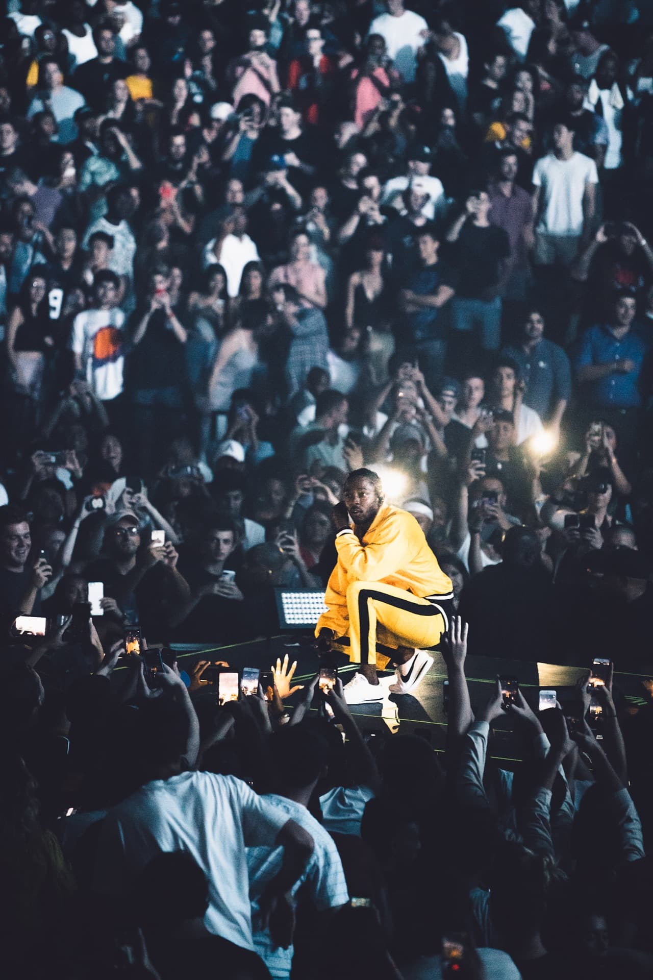 Kendrick Lamar live in concert under stage lights